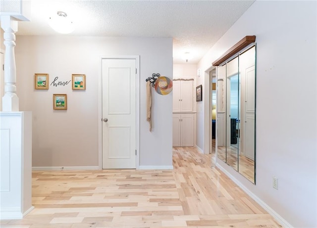 1825 Kings Rd, Edmond, OK 73013 - corridor featuring light wood finished floors and a textured ceiling