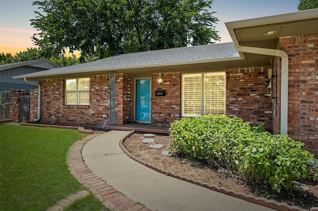 1825 Kings Rd, Edmond, OK 73013 - view of front of house featuring brick siding and roof with shingles