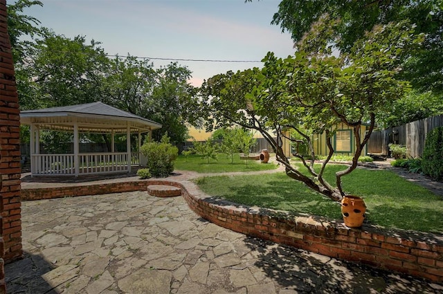 1825 Kings Rd, Edmond, OK 73013 - fenced backyard featuring a gazebo, a patio area, and an outdoor structure