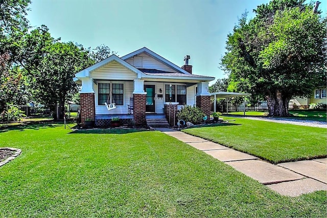 432 S 6th St, Yukon, OK 73099 - view of front of property with a chimney, brick siding, a carport, and a porch