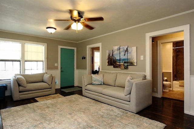 432 S 6th St, Yukon, OK 73099 - living area featuring dark wood-style flooring, a ceiling fan, a wainscoted wall, crown molding, and healthy amount of natural light