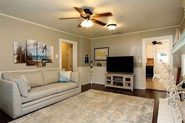 432 S 6th St, Yukon, OK 73099 - living room featuring ceiling fan, dark wood-style flooring, crown molding, and a wainscoted wall