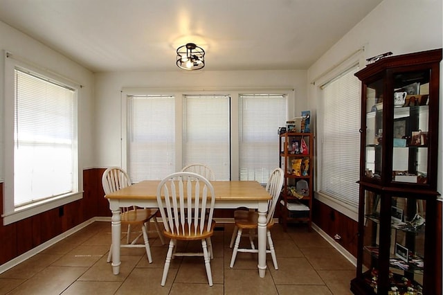 432 S 6th St, Yukon, OK 73099 - dining room with light tile patterned floors, wainscoting, and wood walls