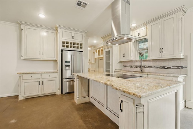 5801 N Henney Rd, Coyle, OK 73027 - kitchen featuring stainless steel fridge, island exhaust hood, concrete flooring, black electric cooktop, and decorative backsplash