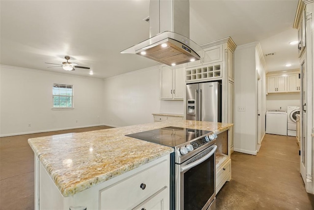 5801 N Henney Rd, Coyle, OK 73027 - kitchen with stainless steel appliances, island exhaust hood, separate washer and dryer, ornamental molding, and ceiling fan