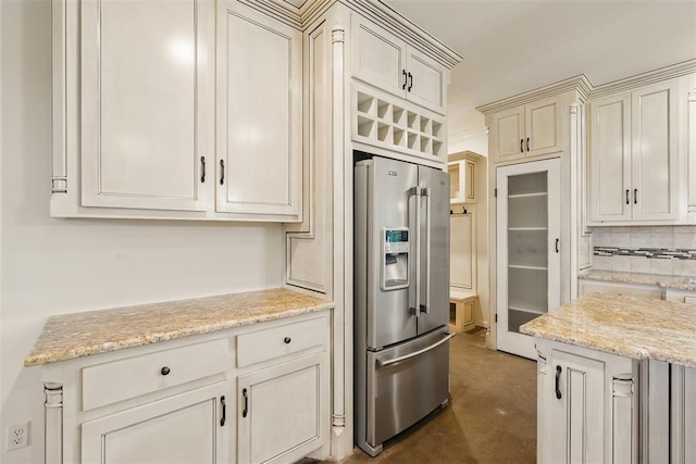 5801 N Henney Rd, Coyle, OK 73027 - kitchen with stainless steel fridge with ice dispenser, concrete flooring, light stone countertops, and decorative backsplash