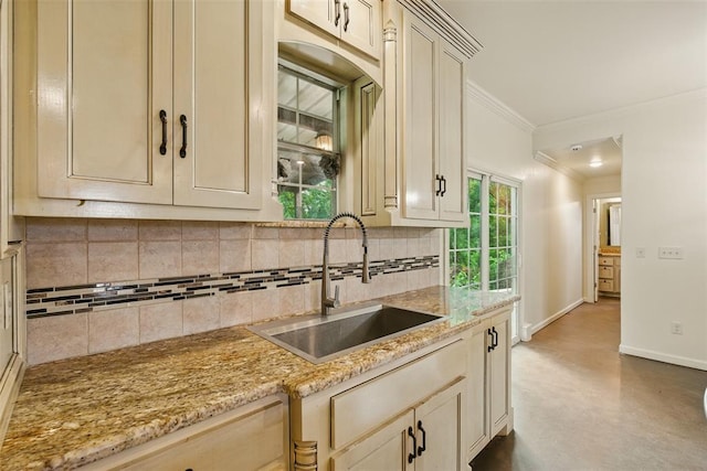 5801 N Henney Rd, Coyle, OK 73027 - kitchen with crown molding, tasteful backsplash, light stone countertops, finished concrete flooring, and cream cabinets
