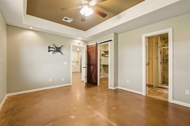 5801 N Henney Rd, Coyle, OK 73027 - unfurnished bedroom with a raised ceiling, finished concrete floors, a barn door, a walk in closet, and crown molding