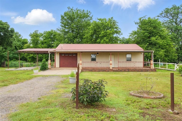 5801 N Henney Rd, Coyle, OK 73027 - view of front of home with an attached garage, gravel driveway, board and batten siding, covered porch, and a metal roof