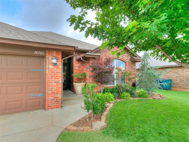 10705 SW 36th St, Yukon, OK 73099 - doorway to property with a yard, brick siding, and roof with shingles