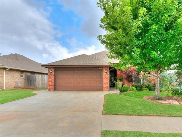 10705 SW 36th St, Yukon, OK 73099 - view of front of house featuring an attached garage, driveway, brick siding, and a shingled roof
