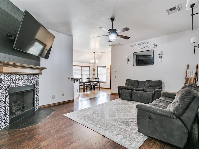 10705 SW 36th St, Yukon, OK 73099 - living room featuring a ceiling fan, a chandelier, hardwood / wood-style flooring, and a fireplace