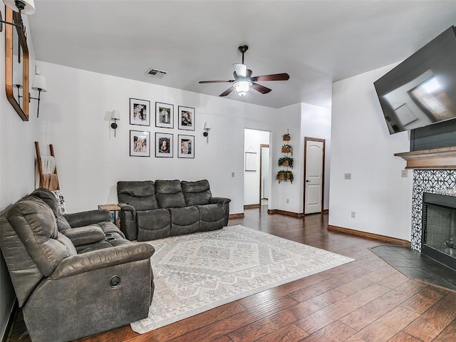 10705 SW 36th St, Yukon, OK 73099 - living area featuring a ceiling fan, dark wood-style floors, and a fireplace