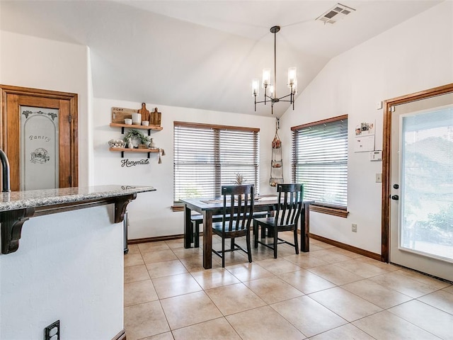 10705 SW 36th St, Yukon, OK 73099 - dining room with lofted ceiling, a chandelier, and light tile patterned floors