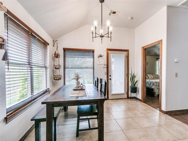 10705 SW 36th St, Yukon, OK 73099 - dining area with a chandelier, vaulted ceiling, and light tile patterned floors