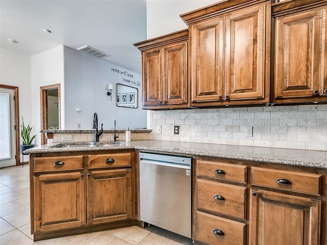 10705 SW 36th St, Yukon, OK 73099 - kitchen with dishwasher, a peninsula, tasteful backsplash, light tile patterned floors, and brown cabinets