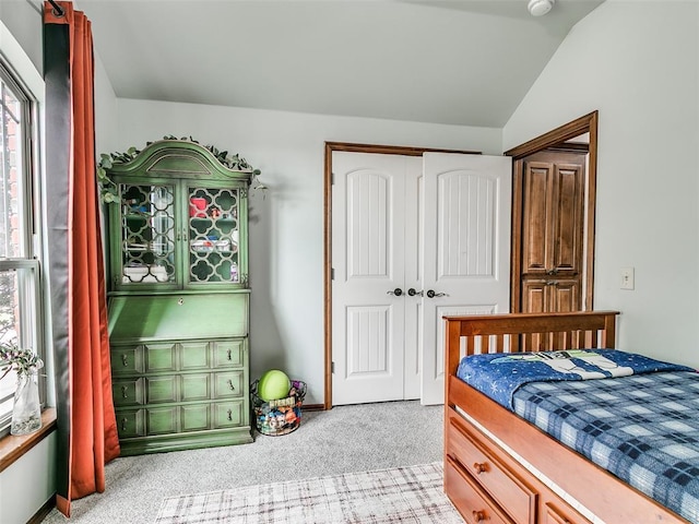 10705 SW 36th St, Yukon, OK 73099 - bedroom featuring light carpet, vaulted ceiling, and a closet