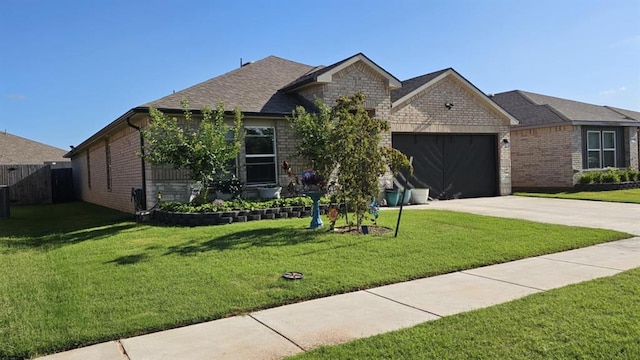 11704 SW 40th St, Mustang, OK 73064 - view of front facade with driveway, a garage, brick siding, and roof with shingles