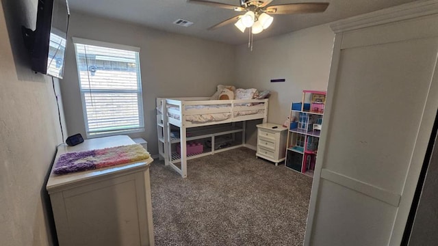 11704 SW 40th St, Mustang, OK 73064 - bedroom with dark carpet and a ceiling fan