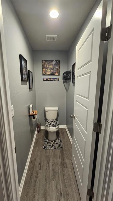 11704 SW 40th St, Mustang, OK 73064 - bathroom featuring wood finished floors and toilet
