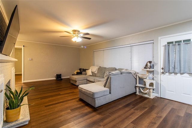 1712 N Pennsylvania Ave, Shawnee, OK 74804 - living area featuring crown molding, a ceiling fan, dark wood-style flooring, and a brick fireplace