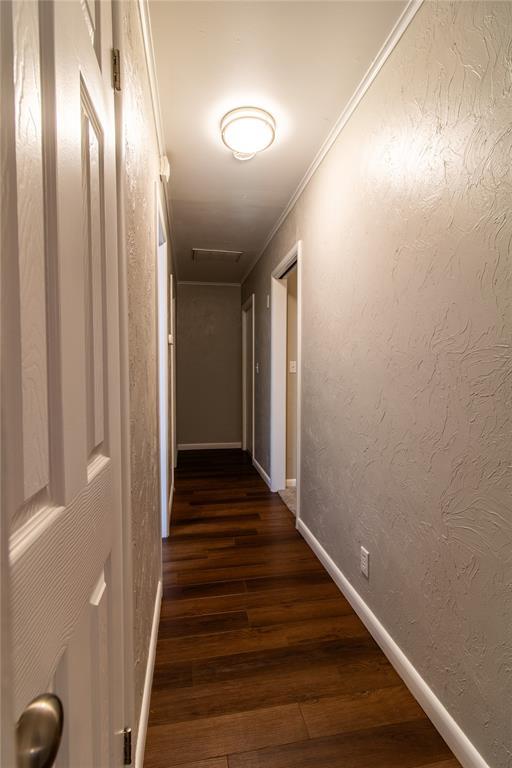 1712 N Pennsylvania Ave, Shawnee, OK 74804 - hall featuring dark wood-style floors, attic access, and ornamental molding