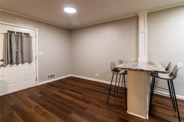 1712 N Pennsylvania Ave, Shawnee, OK 74804 - unfurnished dining area with dark wood-style floors and ornamental molding