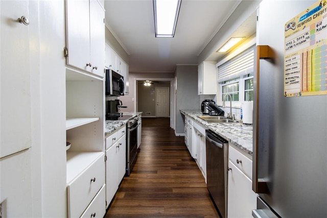 1712 N Pennsylvania Ave, Shawnee, OK 74804 - kitchen with stainless steel appliances, dark wood-type flooring, white cabinetry, ceiling fan, and crown molding