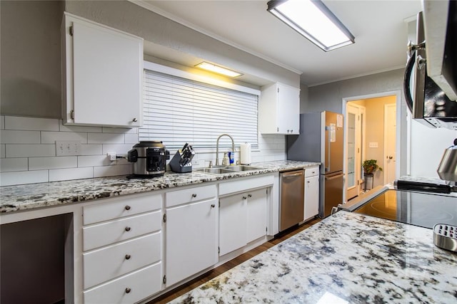 1712 N Pennsylvania Ave, Shawnee, OK 74804 - kitchen featuring stainless steel appliances, tasteful backsplash, white cabinets, dark wood-style floors, and crown molding