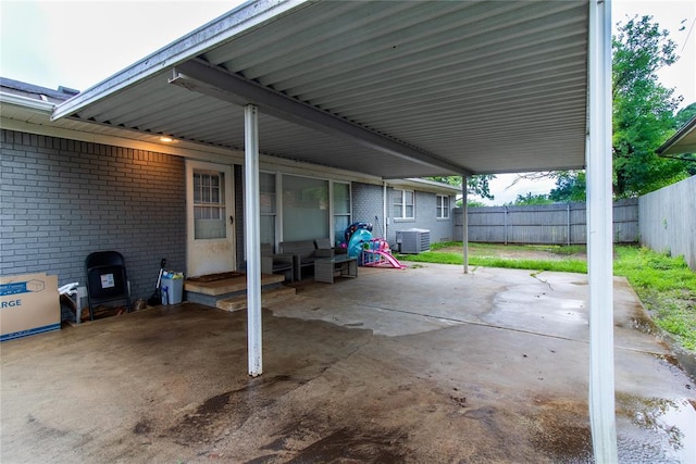 1712 N Pennsylvania Ave, Shawnee, OK 74804 - fenced backyard featuring a carport and a patio area