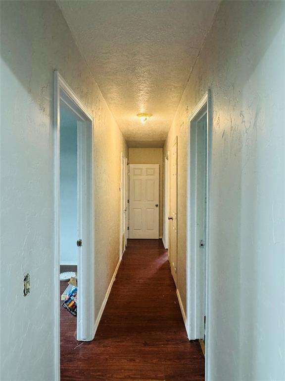 104 S Ross St, Walters, OK 73572 - hallway featuring dark wood-style flooring and a textured ceiling