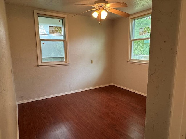 104 S Ross St, Walters, OK 73572 - unfurnished room with dark wood-type flooring and ceiling fan