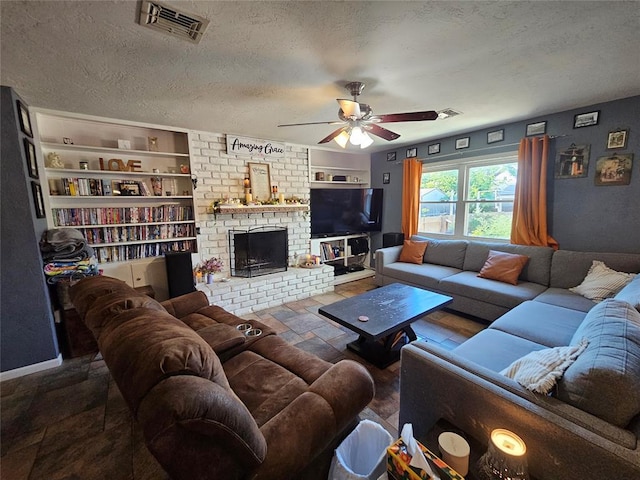 3205 NW 62nd St, Oklahoma City, OK 73112 - living room featuring a ceiling fan, a textured ceiling, built in features, and a brick fireplace