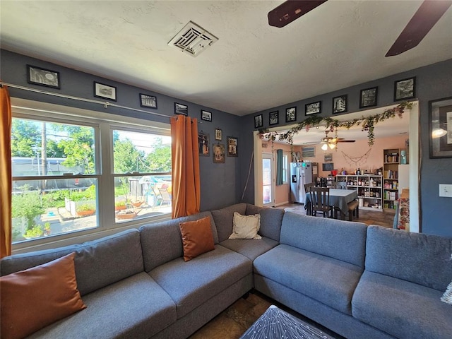 3205 NW 62nd St, Oklahoma City, OK 73112 - living room featuring a ceiling fan and plenty of natural light