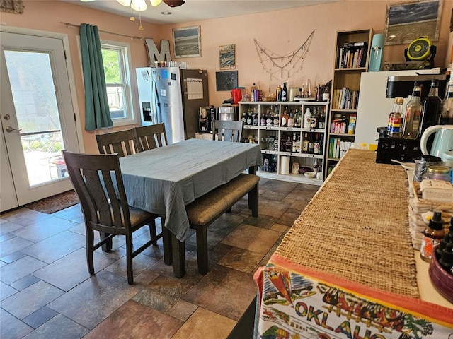 3205 NW 62nd St, Oklahoma City, OK 73112 - dining area featuring ceiling fan and stone tile floors