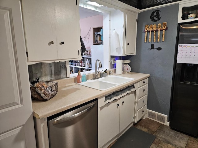 3205 NW 62nd St, Oklahoma City, OK 73112 - kitchen featuring dishwasher, freestanding refrigerator, light countertops, white cabinets, and a textured wall