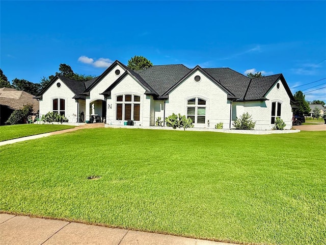 1118 Fernwood Dr, Midwest City, OK 73130 - french country style house featuring brick siding and a front lawn