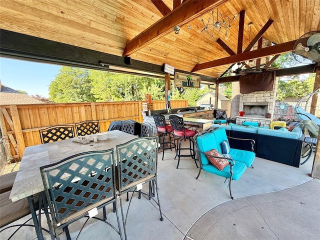 1118 Fernwood Dr, Midwest City, OK 73130 - fenced backyard featuring a patio area, an outdoor living space with a fireplace, and outdoor dining space