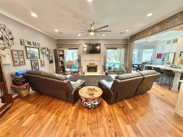 1118 Fernwood Dr, Midwest City, OK 73130 - living area featuring ceiling fan, light wood-style floors, ornamental molding, recessed lighting, and a fireplace