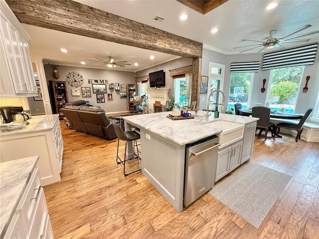 1118 Fernwood Dr, Midwest City, OK 73130 - kitchen with stainless steel dishwasher, a ceiling fan, open floor plan, crown molding, and a fireplace