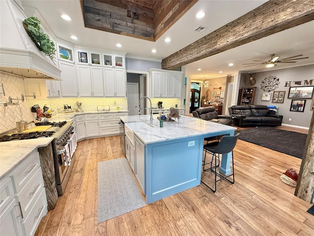 1118 Fernwood Dr, Midwest City, OK 73130 - kitchen featuring high end stainless steel range oven, custom range hood, light stone counters, white cabinets, and recessed lighting