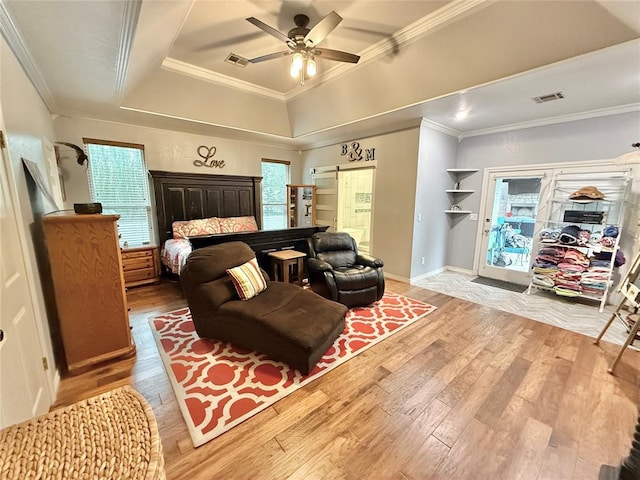1118 Fernwood Dr, Midwest City, OK 73130 - bedroom with ornamental molding, light wood-style flooring, a raised ceiling, and ceiling fan