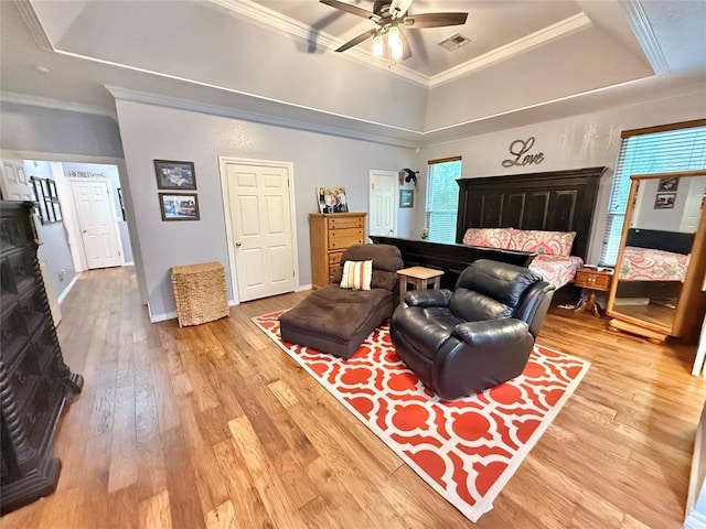 1118 Fernwood Dr, Midwest City, OK 73130 - bedroom with a raised ceiling, light wood-style flooring, and crown molding