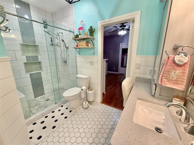 1118 Fernwood Dr, Midwest City, OK 73130 - full bathroom featuring a stall shower, a ceiling fan, a wainscoted wall, vanity, and tile patterned floors