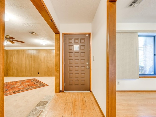 7600 NW 27th St, Bethany, OK 73008 - foyer featuring wood finished floors, a textured ceiling, and a ceiling fan