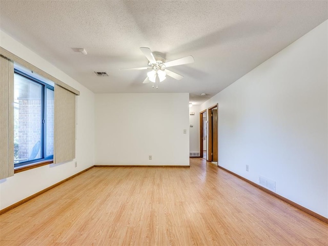 7600 NW 27th St, Bethany, OK 73008 - spare room with light wood-style flooring, ceiling fan, and a textured ceiling