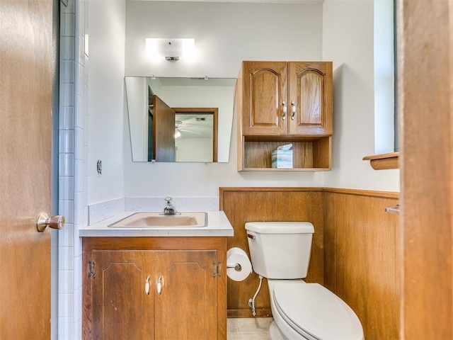 7600 NW 27th St, Bethany, OK 73008 - bathroom featuring vanity, a wainscoted wall, and ceiling fan