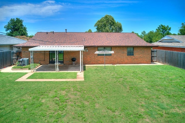 7600 NW 27th St, Bethany, OK 73008 - back of house featuring a fenced backyard, a patio area, brick siding, and roof with shingles