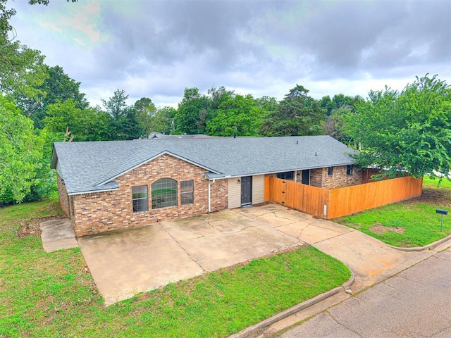 535 N Patchin Ave, Shawnee, OK 74801 - ranch-style home with roof with shingles, brick siding, and concrete driveway