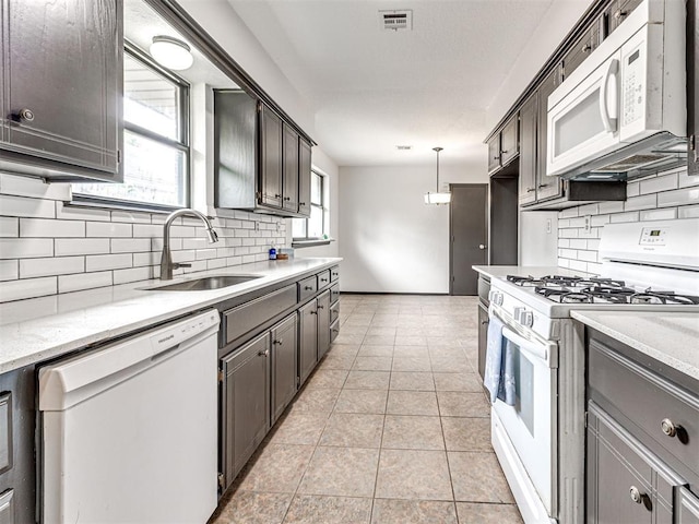 535 N Patchin Ave, Shawnee, OK 74801 - kitchen with white appliances, decorative backsplash, light tile patterned flooring, and light stone countertops